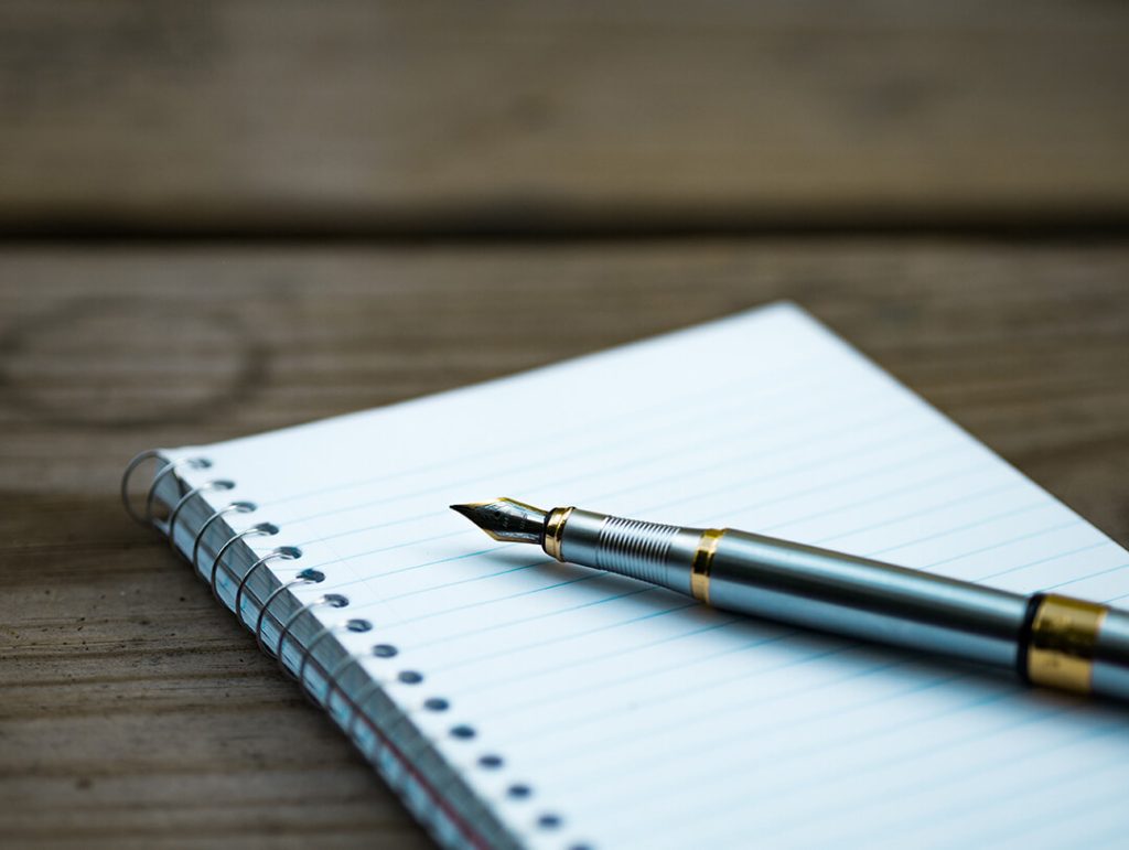 A notebook and a fountain pen
