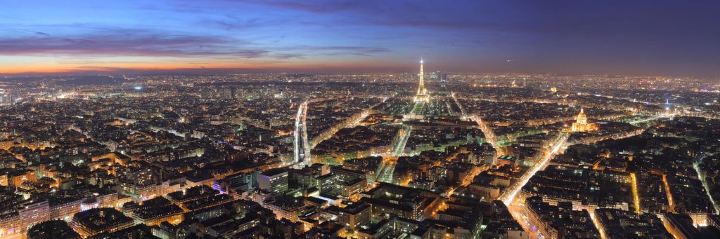 Paris at night seen from above, with the Eiffel Tower